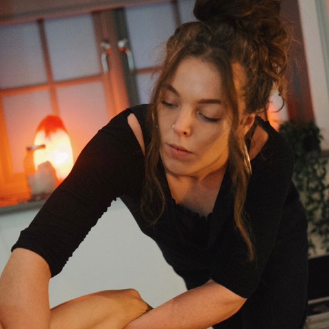 Katie Lancaster at work in her candlelit treatment room