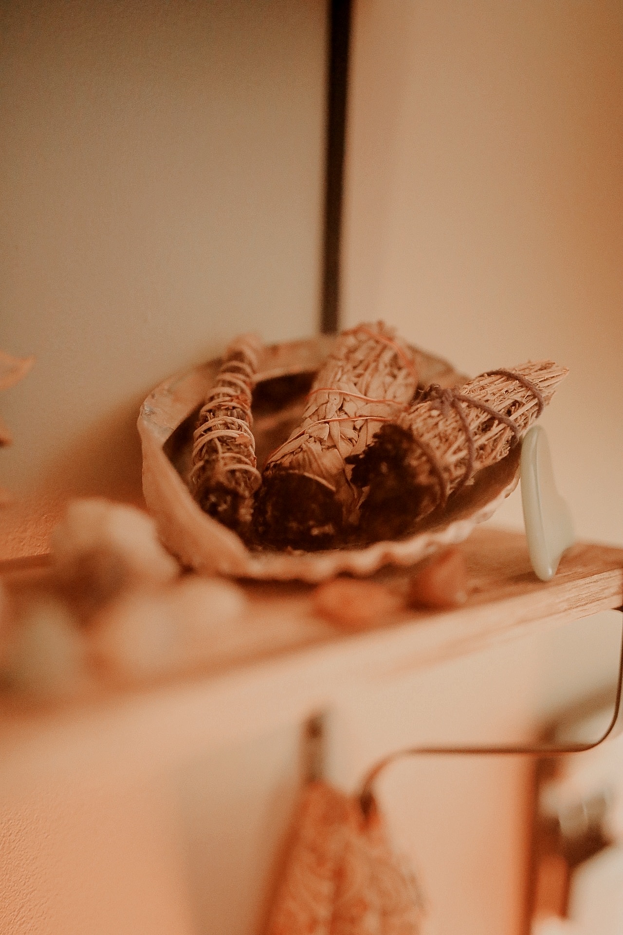 Sage bundles resting in a shell in the treatment room